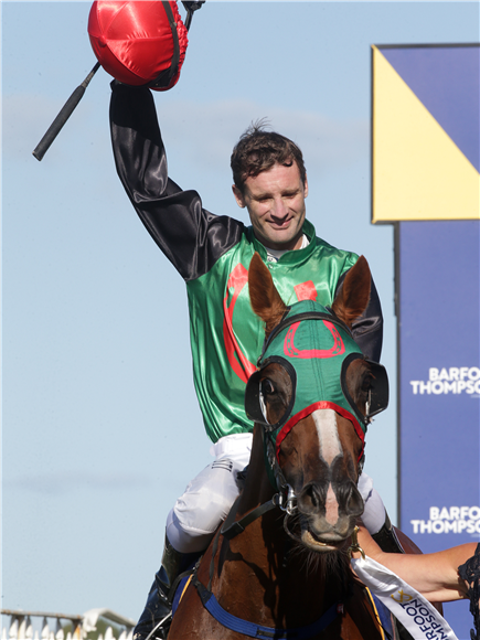 Rider Johnathan Parkes acknowledges the crowd as he returns aboard Gr.1 Barfoot & Thompson Auckland Cup (3200m) winner Ocean Billy