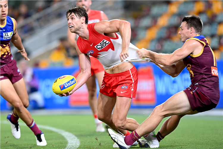 DANE RAMPE of the Swans is taken over the boundary line by Lincoln McCarthy of the Lions during the AFL match between the Brisbane Lions and the Sydney Swans at Brisbane, Australia.