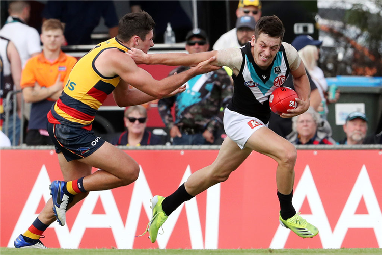 ZAK BUTTERS of Port Adelaide tries to get away during the AAMI Community Series match between the Adelaide Crows and the Port Adelaide Power at Flinders University Stadium in Adelaide, Australia.