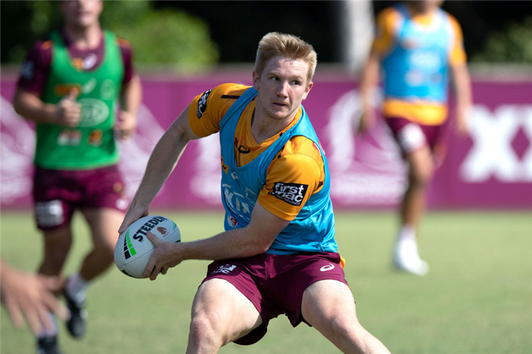 TOM DEARDEN looks to pass during a NRL training session at the Clive Berghofer Centre in Brisbane, Australia.