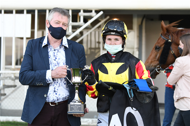 Peter Didham and Sarah Macnab pose with the winning trophy after taking out the feature event at Awapuni with House Of Cartier