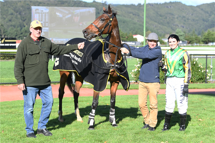 Owner Neil O’Dowd (left), trainer Clinton Isdale and jockey Emily Farr pose with Aigne after his win in the Manawatu ITM Awapuni Hurdles (2900m) at Trentham