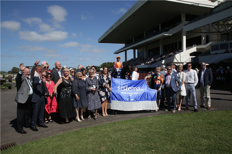 Members of the Te Akau Buckle Up Racing Partnership, who own Entriviere, pose for a winning photo at Ellerslie