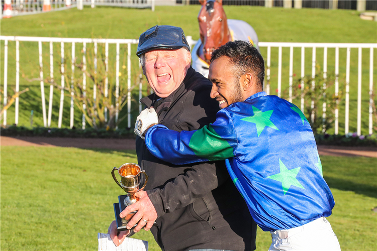 Jockey Rohan Mudhoo celebrates with trainer Mike McCann