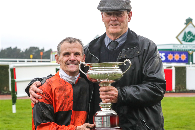 Trainer Bevan Wilson and jockey Terry Moseley pose with the Winter Cup trophy after their victory with Lord Darci