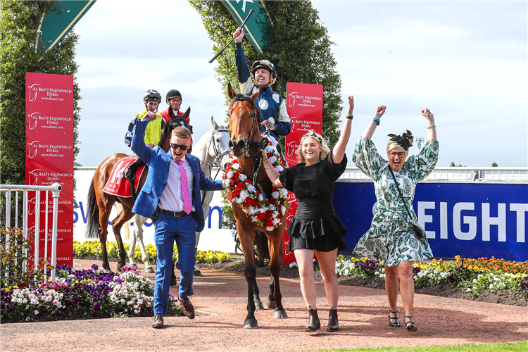 A jubilant Michael McNab shares the joy of a Group One win with members of the Weatherley family (L-R Sam, Briar and Lou) as they bring Pier back to the Riccarton birdcage