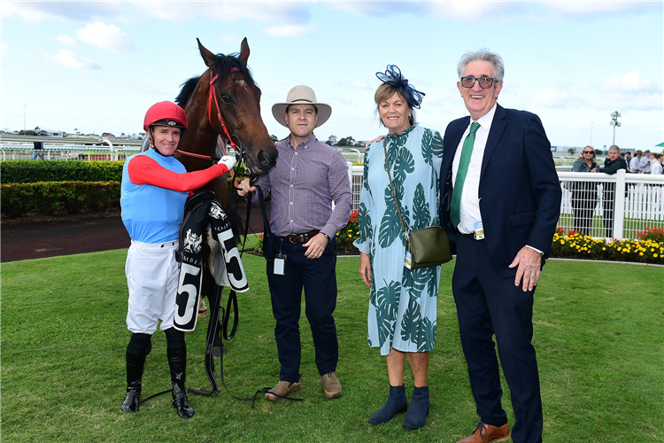 Owners John and Carole Lynskey pose with Puntura after his win at Doomben