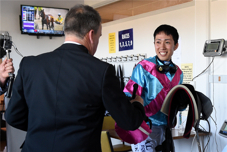 A smiling Yuto Kumagai prepares to weigh in after his victory at Tauranga

