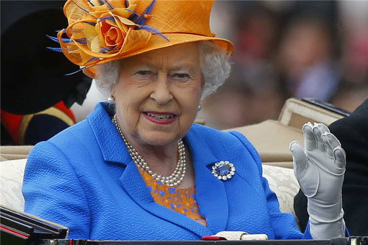 Her Majesty the Queen during the royal procession waving to racegoers