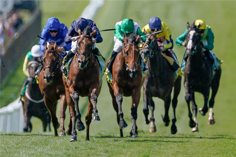 CITY OF TROY (L, dark blue cap) winning the Superlative Stakes at Newmarket in England.