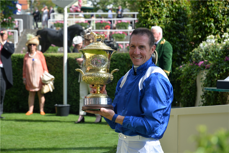 Winning jockey Jim Crowley holding the 2023 Prince of Wales' Stakes trophy won by Mostahdaf.