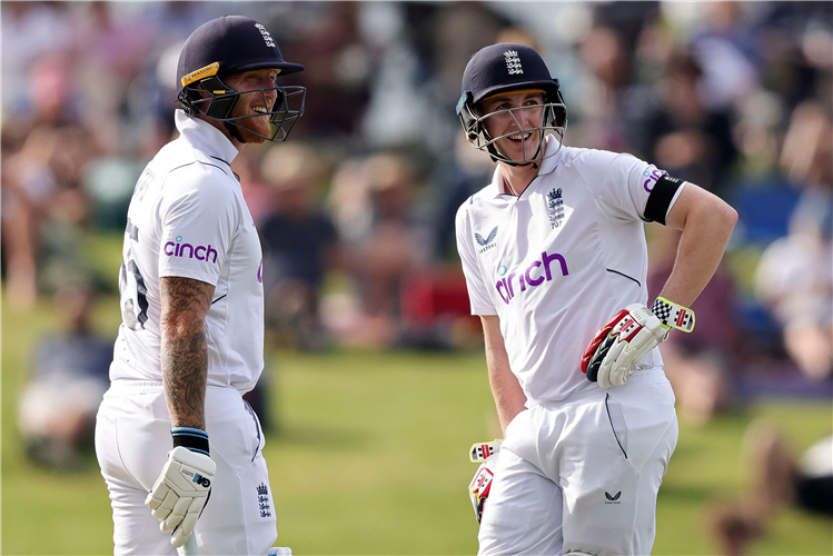 England's batters Ben Stokes (left) and Harry Brook (right) rest between overs against New Zealand.