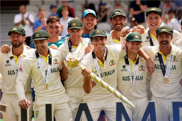 Australia’s Pat Cummins and team-mates celebrate with their trophy following victory over India