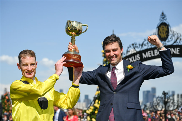 Mark Zahra poses with trainer Sam Freedman after riding Without A Fight to win the Melbourne Cup at Flemington in Melbourne, Australia.
