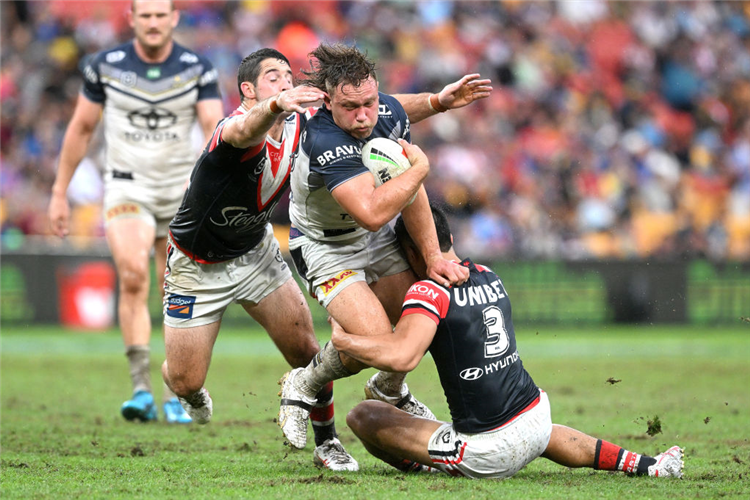 REUBEN COTTER of the Cowboys takes on the defence during the NRL match between Sydney Roosters and North Queensland Cowboys at Suncorp Stadium in Brisbane, Australia.