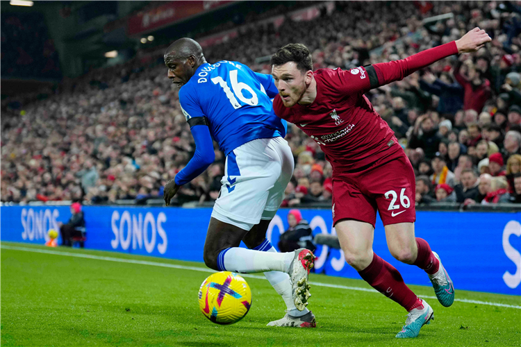 Everton's Abdoulaye Doucoure is challenged by Liverpool's Andy Robertson