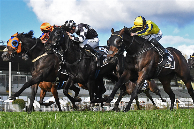 Freeze Frame (outside) chases down Sumi (centre) and Karman Line to score on Saturday at Te Rapa.