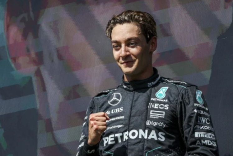 George Russell on the podium after 2024 Belgian GP victory.