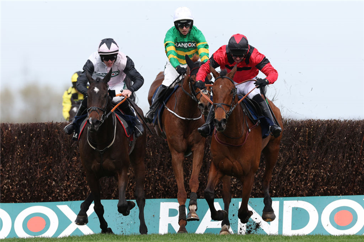 GERRI COLOMBE (right, red/black cap) winning the Bowl Chase at Aintree in Liverpool, England.