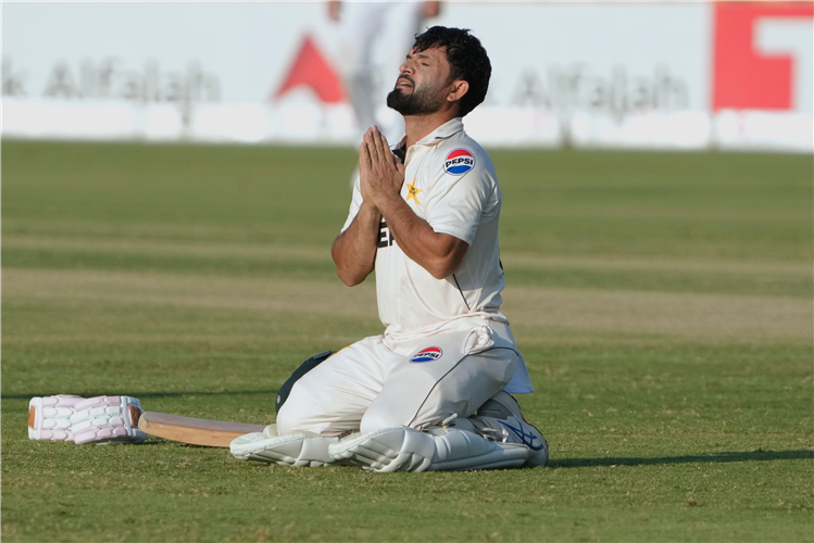 Pakistan's Kamran Ghulam celebrates his debut ton against England in Multan