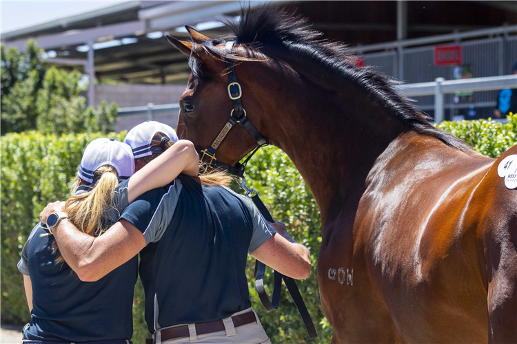 Mungrup staff embrace after their Playing God filly sold for $625,000.