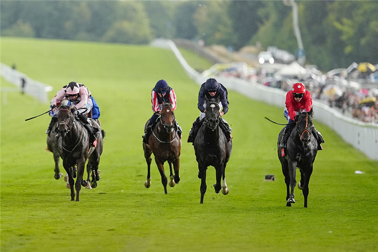 COPPULL (right, red silks) winning the Richmond Stakes at Goodwood in Chichester, England.