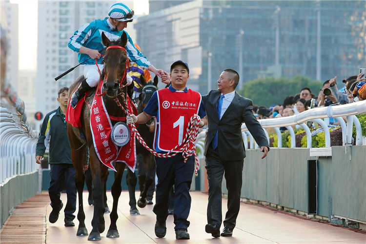 Trainer Danny Shum congratulates James McDonald and Romantic Warrior.