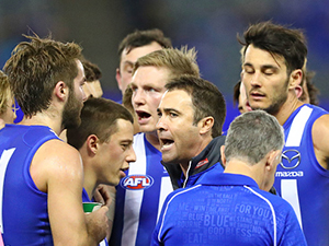 BRAD SCOTT coach of the Kangaroos speaks to his team during a quarter time break with Jack Ziebell of the Kangaroos during an AFL match between the North Melbourne Kangaroos and the Fremantle Dockers at Etihad Stadium in Melbourne, Australia.