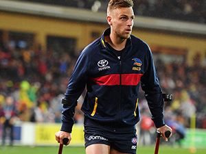 Brodie Smith of the Crows walks from the field with a suspected knee injury during their Qualifying Final match against GWS.  September 7, 2017