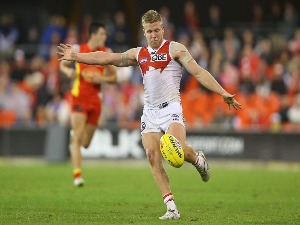 DAN HANNEBERY of the Swans kicks during the AFL match between the Gold Coast Suns and the Sydney Swans at Metricon Stadium in Gold Coast, Australia.