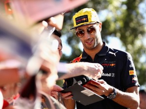 DANIEL RICCIARDO of Australia and Red Bull Racing arrives at the circuit and signs autographs for fans before practice for the Australian Formula One Grand Prix at Albert Park in Melbourne, Australia.