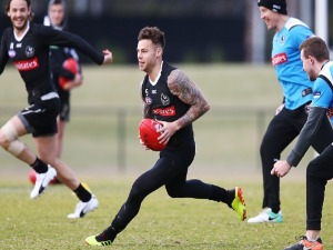 JAMIE ELLIOTT of the Magpies runs with the ball during a Collingwood Magpies AFL training session at Holden Centre in Melbourne, Australia.