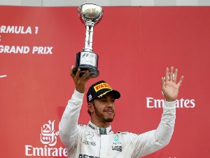 LEWIS HAMILTON of Great Britain and Mercedes GP celebrates on the podium after finishing third during the Formula One Grand Prix of Japan at Suzuka Circuit in Suzuka.