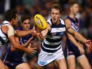 LINCOLN MCCARTHY of the Cats palms the ball to Steven Motlop during the AFL match between the Fremantle Dockers and the Geelong Cats at Domain Stadium in Perth, Australia.