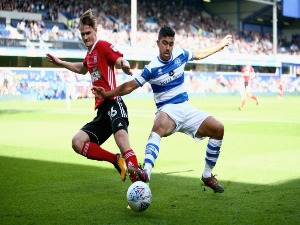 CALLUM CONNOLLY of Ipswich Town and MASSIMO LUONGO of Queens Park Rangers battle for possession during the Sky Bet Championship match between Queens Park Rangers and Ipswich Town at Loftus Road in London, England.