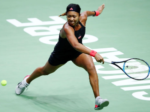 NAOMI OSAKA of Japan plays a backhand in her women's singles match against Angelique Kerber of Germany during the BNP Paribas WTA Finals Singapore presented by SC Global at Singapore Sports Hub in Singapore.