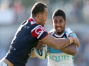 NENE MACDONALD of the Titans is tackled by Blake Ferguson of the Roosters during the NRL match between the Sydney Roosters and the Gold Coast Titans at Central Coast Stadium in Gosford, Australia.