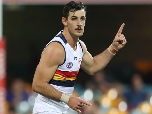 TAYLOR WALKER of the Crows celebrates after kicking a goal during the AFL match between the Brisbane Lions and the Adelaide Crows at The Gabba in Brisbane, Australia.