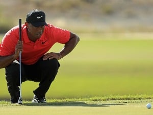 TIGER WOODS of the United States lines up a putt during the Hero World Challenge at Albany in Nassau, Bahamas.