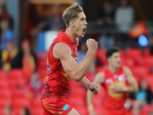 TOM LYNCH of the suns celebrates a goal during the AFL match between the Gold Coast Suns and the Geelong Cats at MS in Gold Coast, Australia.