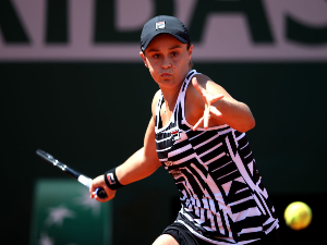 ASHLEIGH BARTY of Australia plays a forehand during her ladies singles quarter-final match of the French Open at Roland Garros in Paris, France.