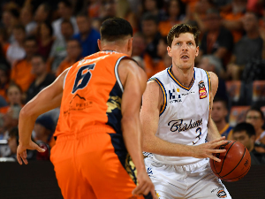 CAMERON GLIDDON of the Bullets looks to get past Jarrod Kenny of the Taipans during the NBL match between the Cairns Taipans and the Brisbane Bullets at Cairns Convention Centre in Cairns, Australia.