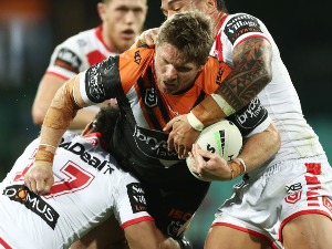 CHRIS LAWRENCE of the Tigers is tackled during the NRL match between the St George Illawarra Dragons and the Wests Tigers at Sydney Cricket Ground in Sydney, Australia.