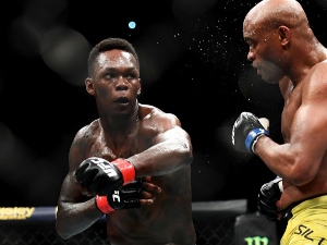 ISRAEL ADESANYA of Nigeria punches ANDERSON SILVA of Brazil during their Middleweight bout during UFC234 at Rod Laver Arena in Melbourne, Australia.