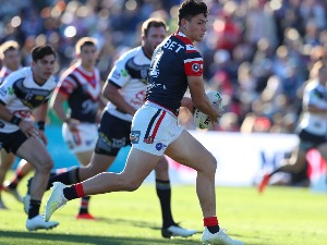 JOSEPH MANU of the Sydney Roosters runs the ball during the NRL match between the Sydney Roosters and the North Queensland Cowboys at Central Coast Stadium in Gosford, Australia.