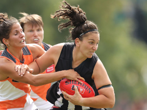 LAUREN TESORIERO of the Magpies is tackled during the AFL Women's match between the Collingwood Magpies and the Greater Western Sydney Giants at Olympic Park in Melbourne, Australia.