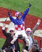 Lee Freedman and Tony Santic celebrate carrying Glen Boss after Makybe Diva wins her 3rd Melbourne Cup